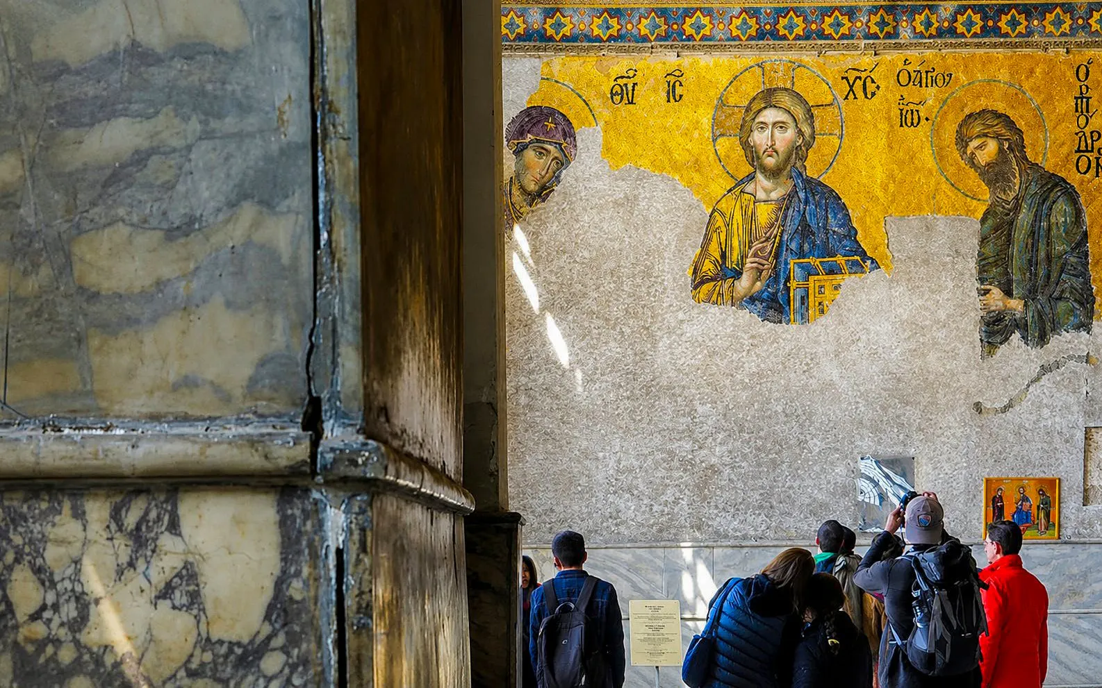 Visitors admire Byzantine mosaics in Hagia Sophia, Istanbul.