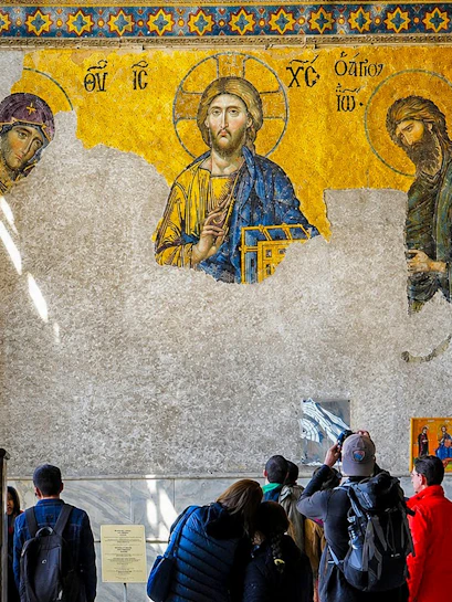 Visitors admire Byzantine mosaics in Hagia Sophia, Istanbul.