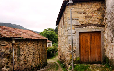 Stone buildings and cobblestone path in Porto mountains during 4x4 Jeep tour.