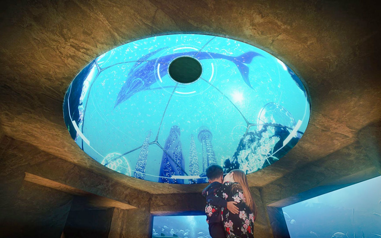 Mother and child viewing underwater exhibit at The Lost World Aquarium.