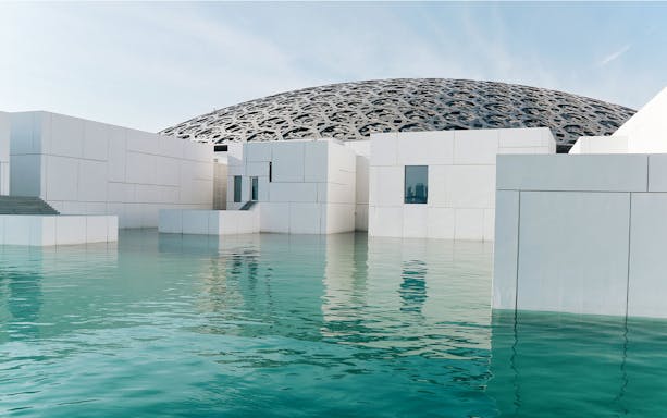 Louvre Museum Abu Dhabi exterior with dome and reflecting water.