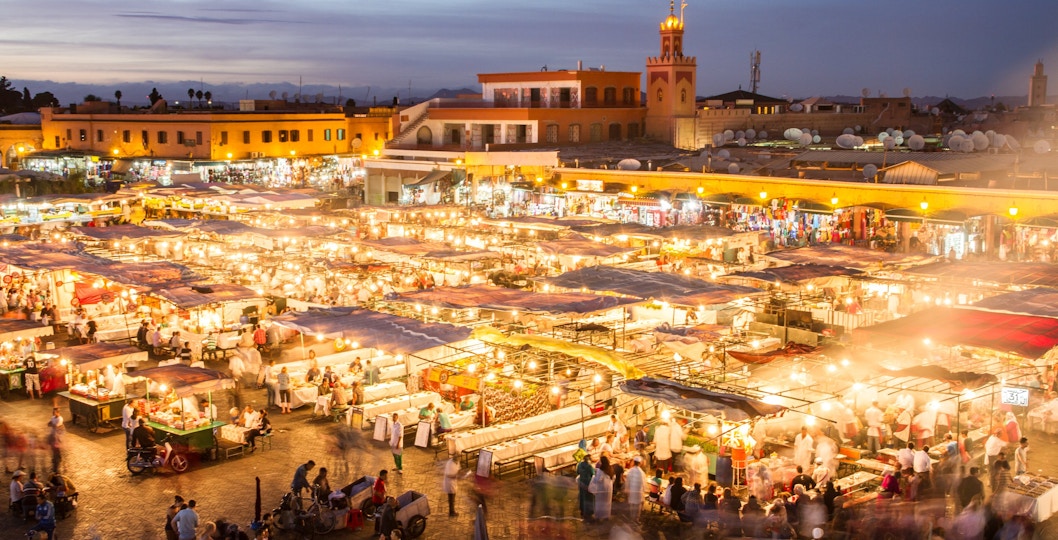 Jamaa el Fna market square bustling with evening activity, Marrakesh, Morocco.
