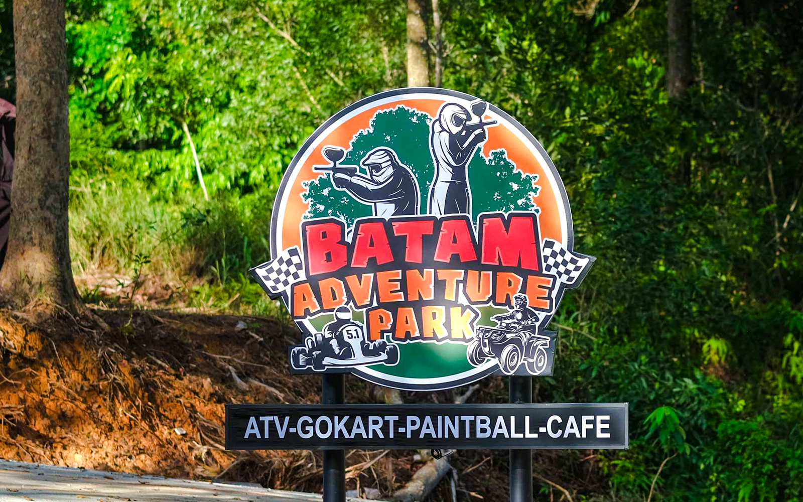 Sign for Batam Adventure Park featuring ATV, go-kart, and paintball activities.