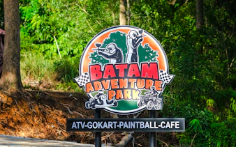 Sign for Batam Adventure Park featuring ATV, go-kart, and paintball activities.