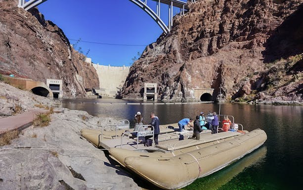 Rafting tour at Black Canyon near Hoover Dam, with tourists boarding the raft.
