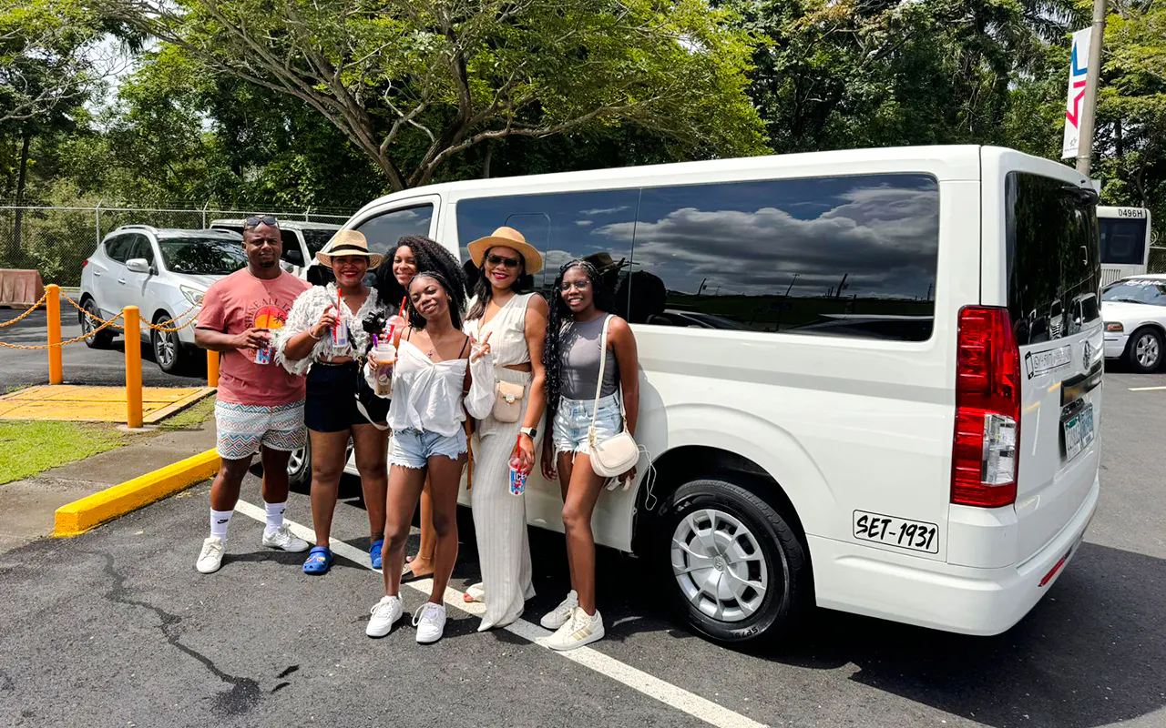 Group of travelers with drinks standing by a white van at Tocumen Airport, Panama City transfer service.
