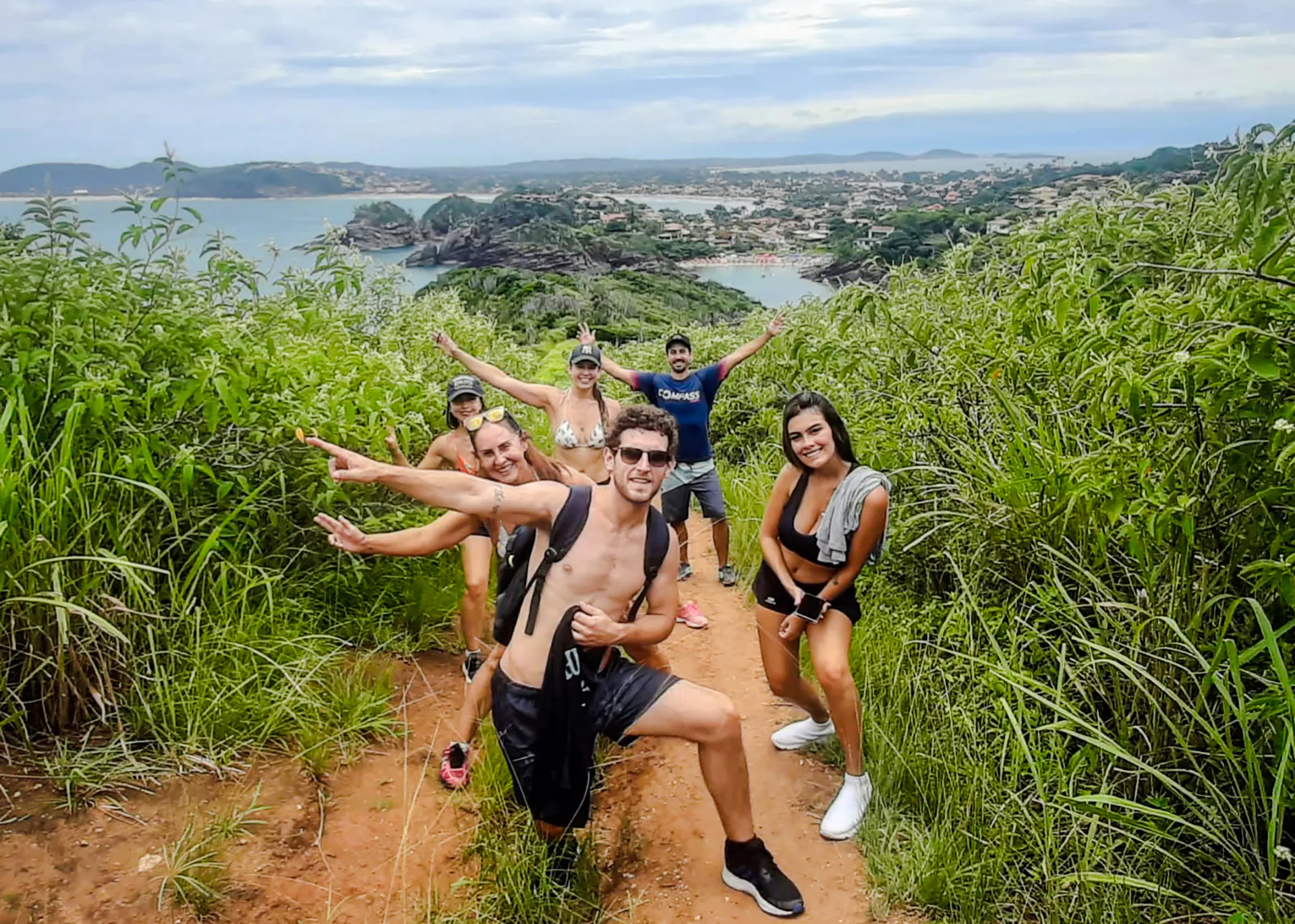 Group hiking in lush greenery with ocean view, Emerências and José Gonçalves, Rio de Janeiro.