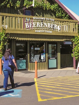 Beerenberg Family Farm entrance in Hahndorf, Australia, with visitor approaching.