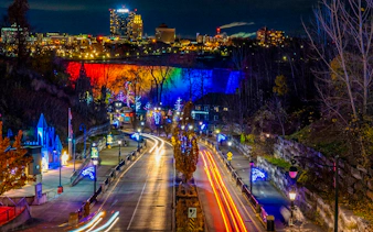 Niagara Falls illuminated with colorful lights during the Festival of Lights Tour.