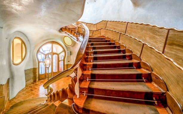 Curved wooden staircase inside Casa Batlló, Barcelona.