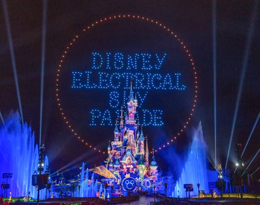 Disneyland Paris Electrical Sky Parade with illuminated floats and characters at night.