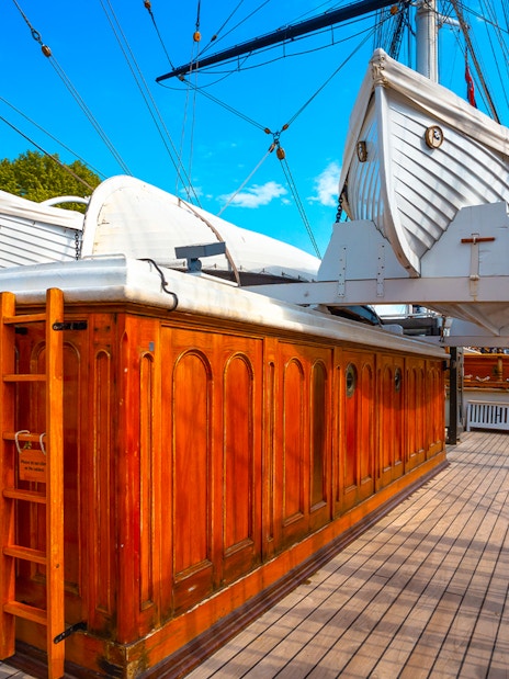 Cutty Sark deck with lifeboats and wooden cabin, Greenwich, London, UK.