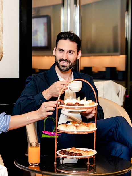 Couple enjoying afternoon tea at Burj Khalifa Level 152 Lounge.