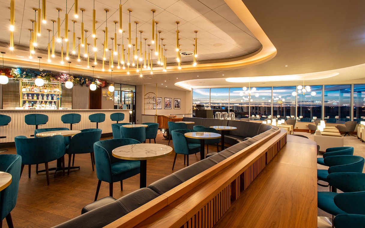Plaza Premium Lounge seating area at Edinburgh Airport with bar and modern decor.