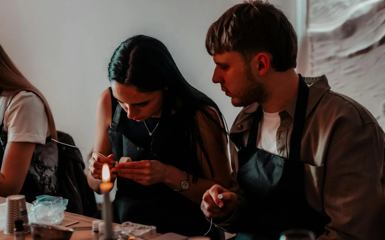 Candle-making workshop participants crafting candles in Krakow studio.