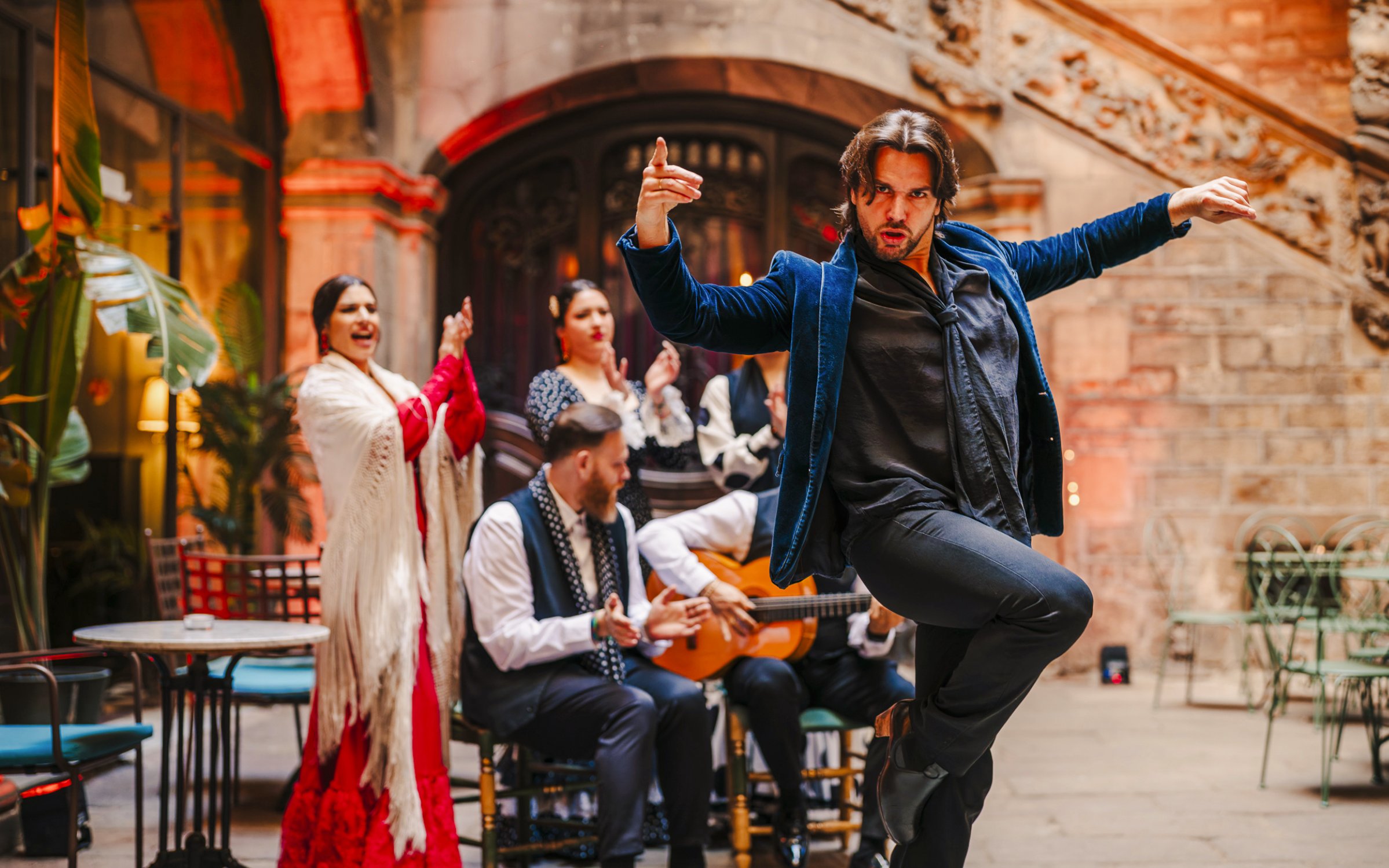 Flamenco dancer performing at Palau Dalmases with musicians in Barcelona.