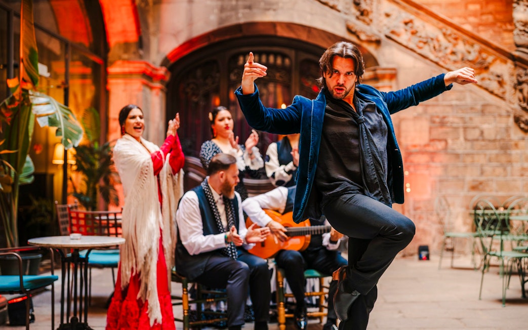 Flamenco dancer performing at Palau Dalmases with musicians in Barcelona.