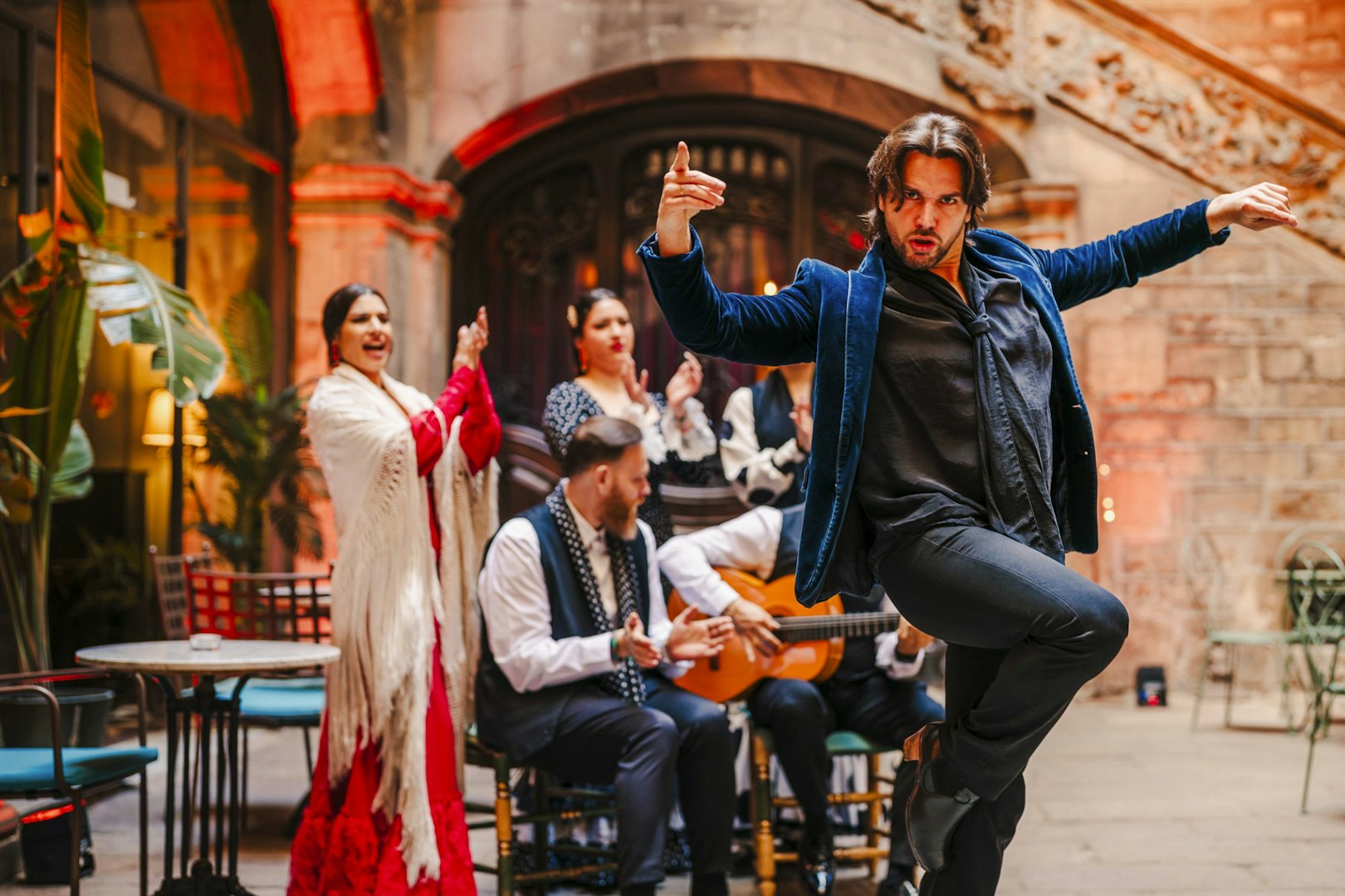 Flamenco dancer performing at Palau Dalmases with musicians in Barcelona.