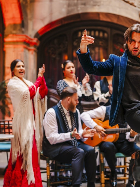 Flamenco dancer performing at Palau Dalmases with musicians in Barcelona.