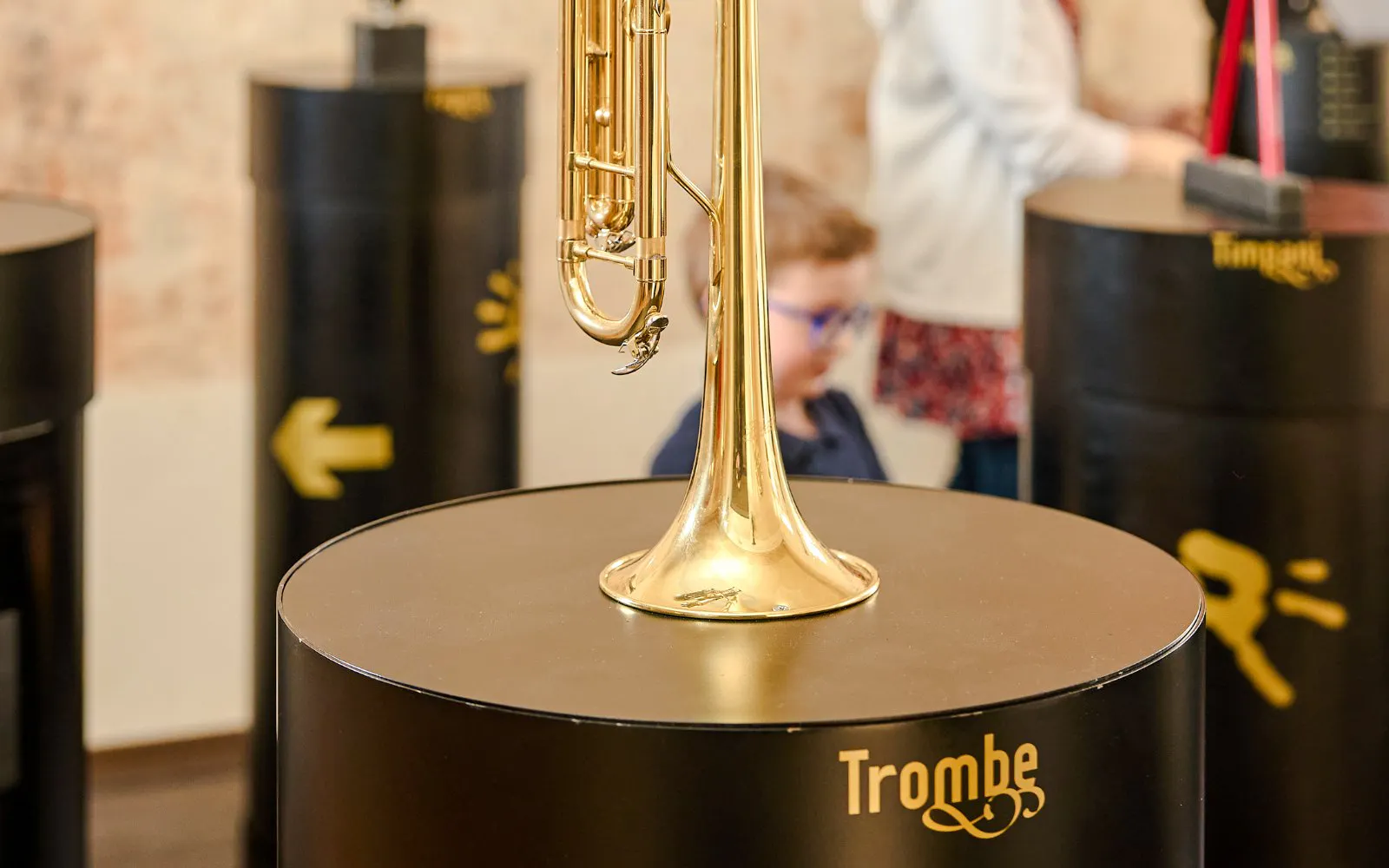 Guests viewing a trumpet exhibit at Mozart Interactive Museum in Prague.