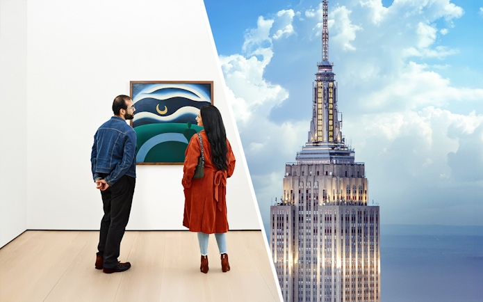Visitors viewing art at The Museum of Modern Art, New York, with Empire State Building.