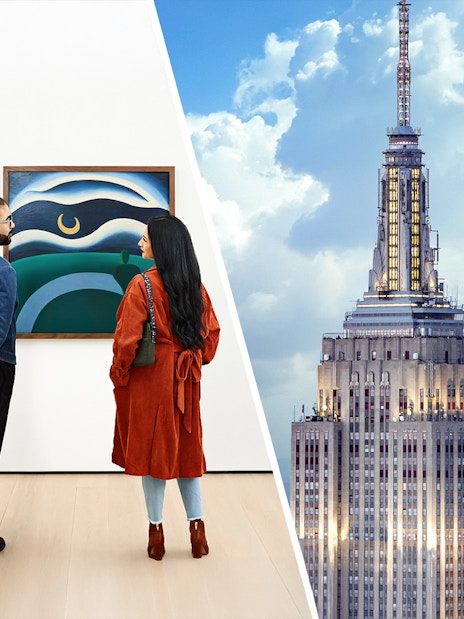 Visitors viewing art at The Museum of Modern Art, New York, with Empire State Building.