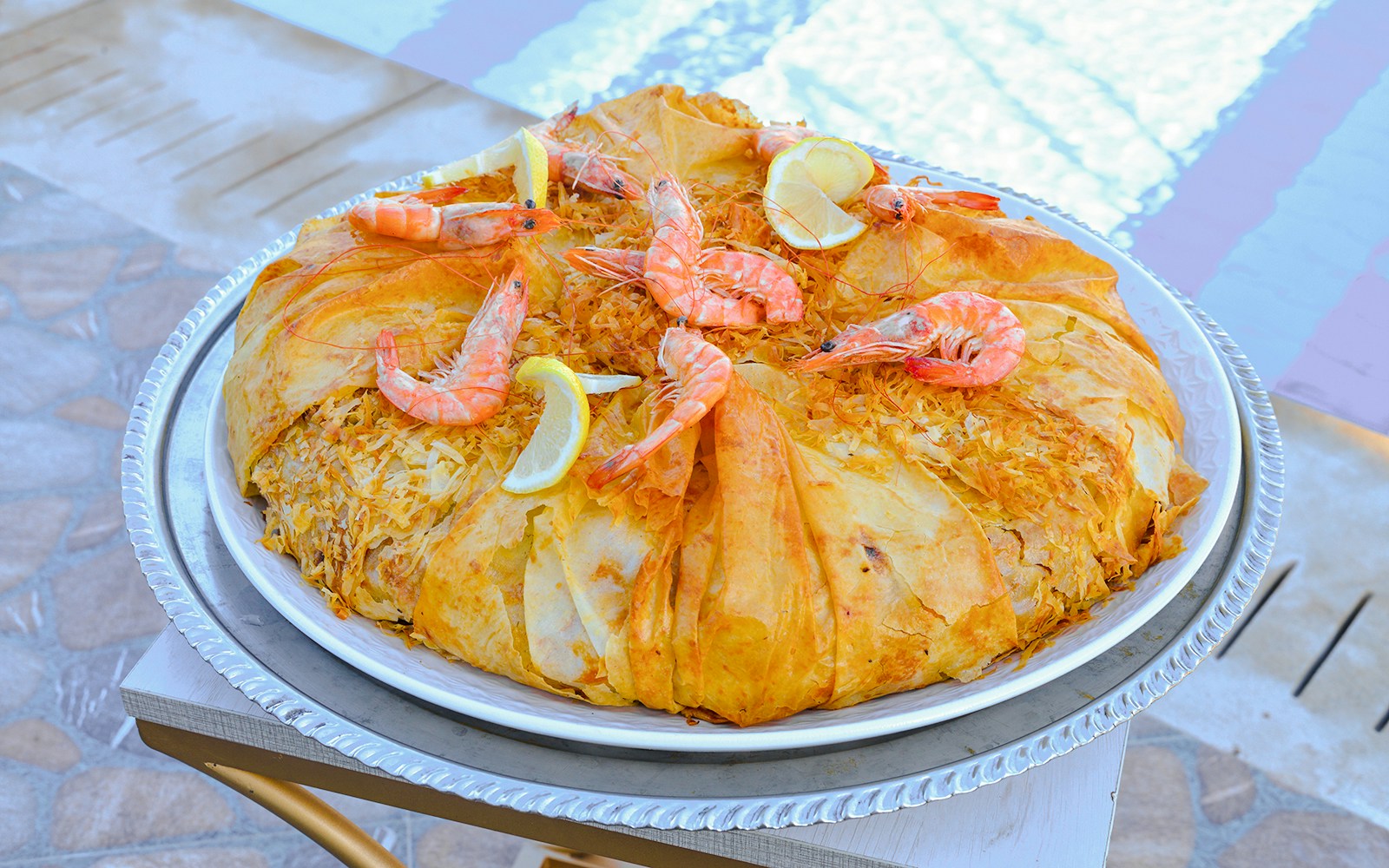 Moroccan pastilla with shrimp and lemon slices at a dinner show in Marrakech.