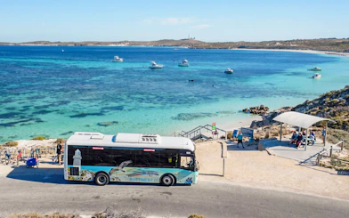 Ferry bus at Rottnest Island with view of turquoise waters and boats in Hillarys.