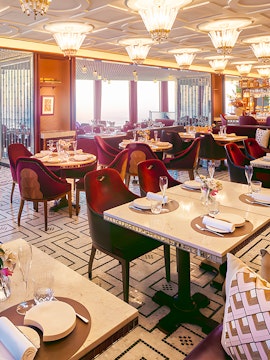 Elegant Dubai restaurant interior with set tables and plush seating.