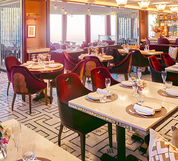 Elegant Dubai restaurant interior with set tables and plush seating.