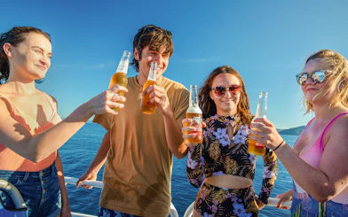 Group enjoying drinks on a boat during Fitzroy Island adventure.