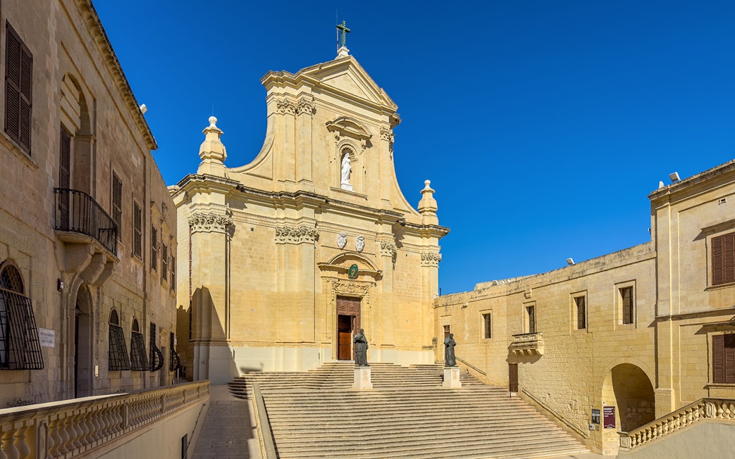 Rabat Cathedral facade with statues and steps on Gozo island, Malta.