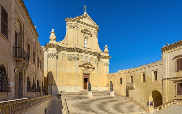 Rabat Cathedral facade with statues and steps on Gozo island, Malta.
