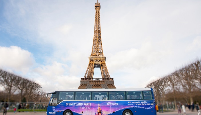 Joyous young girls with Magical shuttle at Disneyland Paris