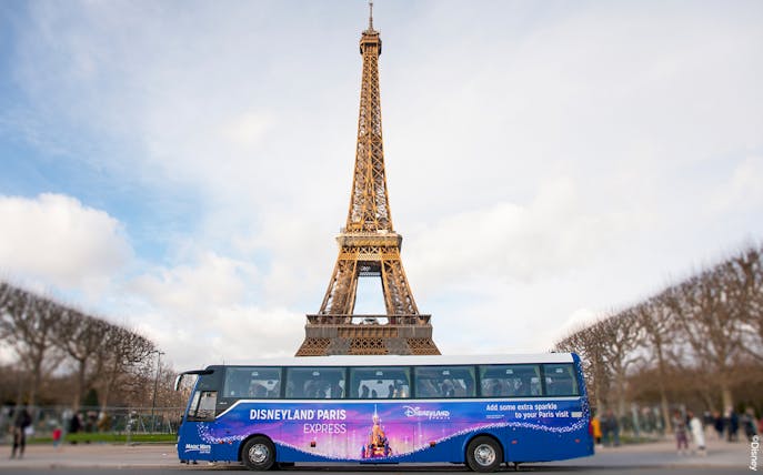Shuttle bus in front of Eiffel Tower for Disneyland Paris tour.