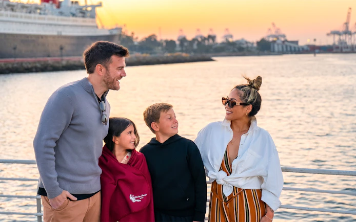 Family enjoying Los Angeles Harbor sightseeing cruise at sunset.