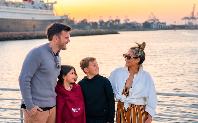 Family enjoying Los Angeles Harbor sightseeing cruise at sunset.