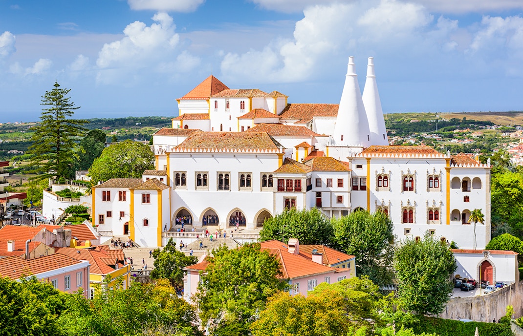 Sintra National Palace Portugal with intricate architecture and twin chimneys against a clear sky.