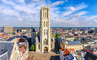 Saint Bavo Cathedral in Ghent, Belgium, with surrounding cityscape.