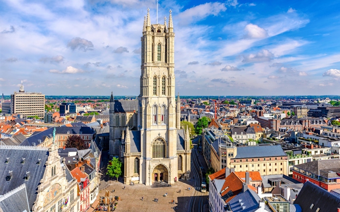 Saint Bavo Cathedral in Ghent, Belgium, with surrounding cityscape.