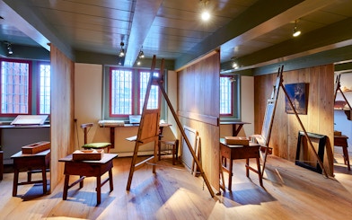 Rembrandt House Museum interior with easels and wooden furniture.