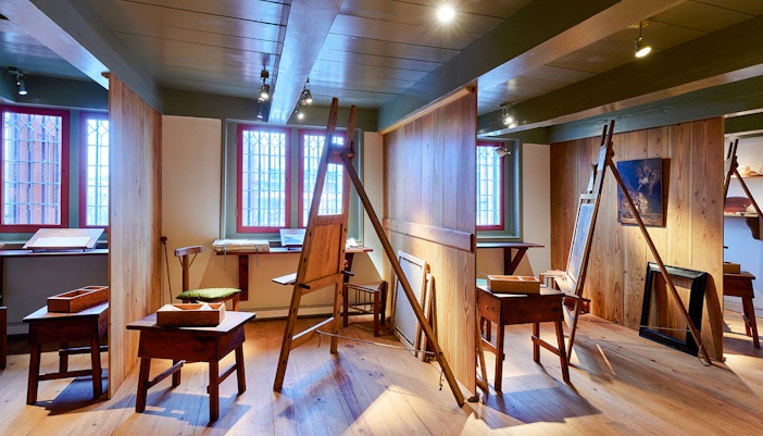 Rembrandt House Museum interior with period furniture and art displays in Amsterdam.