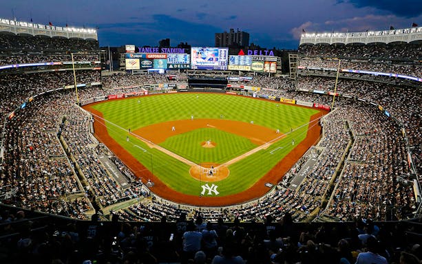 Yankee Stadium during a baseball game in New York City, packed with fans.