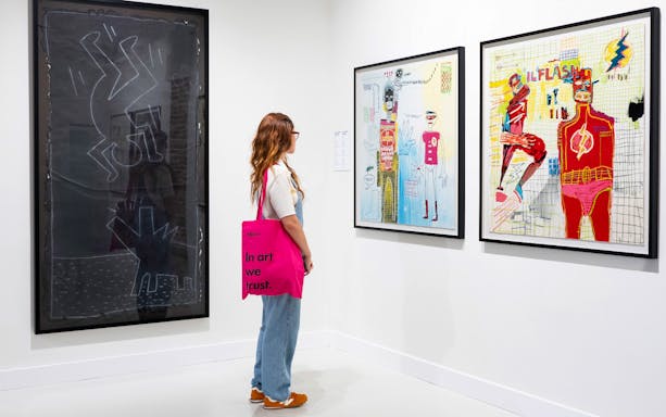 Woman viewing modern art at Moco Museum exhibition.