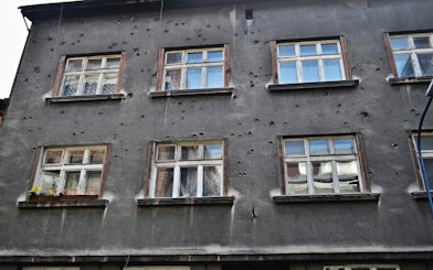 Facade of a building with bullet holes on Piwna Street, Krakow, part of the guided tour to Auschwitz-Birkenau.