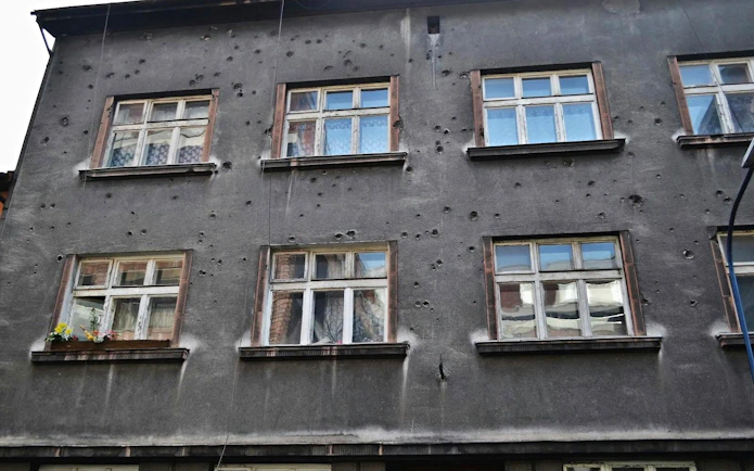 Facade of a building with bullet holes on Piwna Street, Krakow, part of the guided tour to Auschwitz-Birkenau.