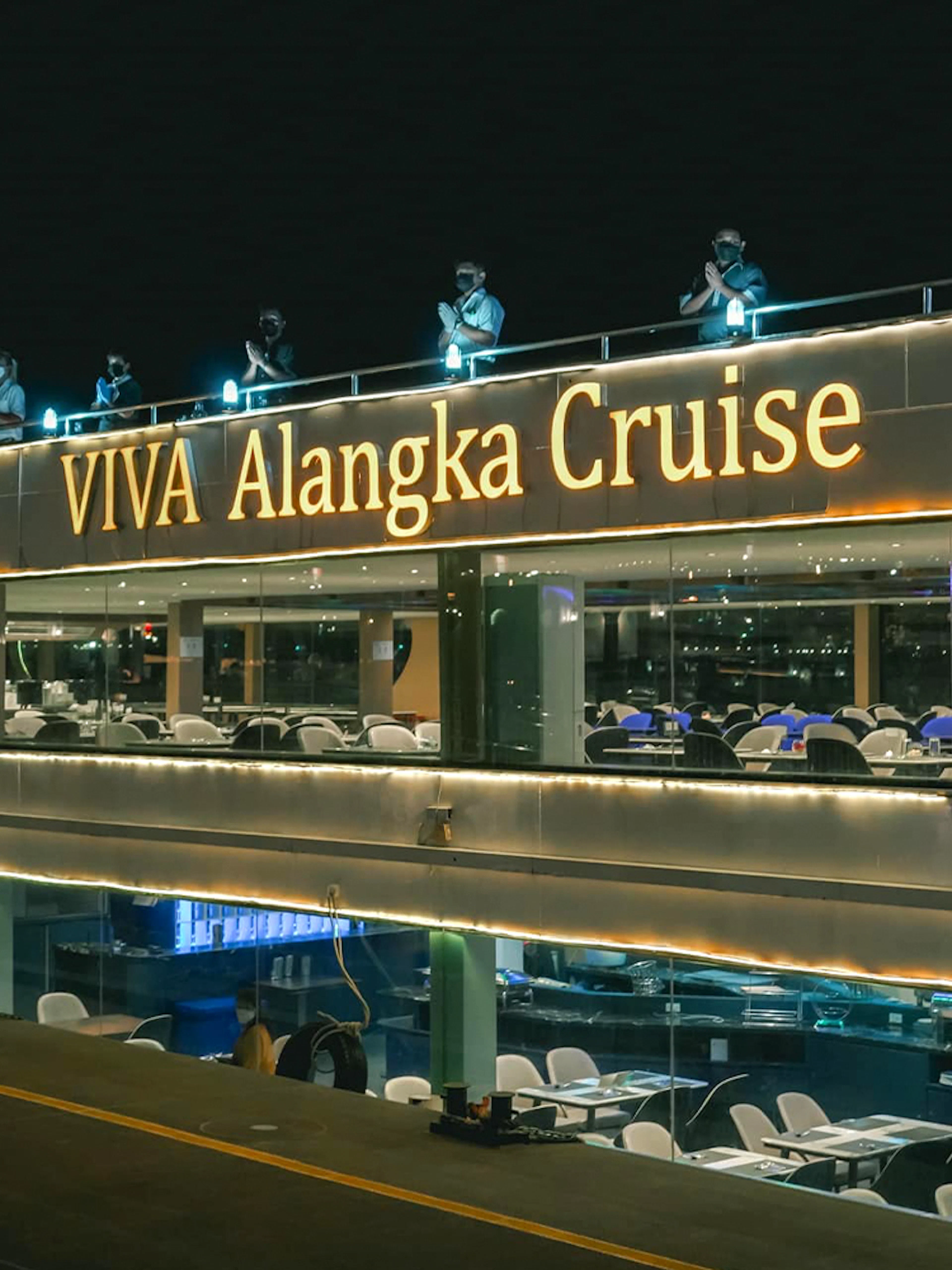 Viva Alangka Cruise docked at Asiatique Pier no.1, illuminated at night.