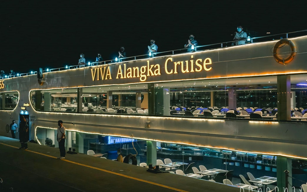 Viva Alangka Cruise docked at Asiatique Pier no.1, illuminated at night.