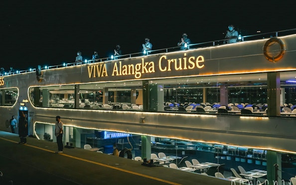 Viva Alangka Cruise docked at Asiatique Pier no.1, illuminated at night.