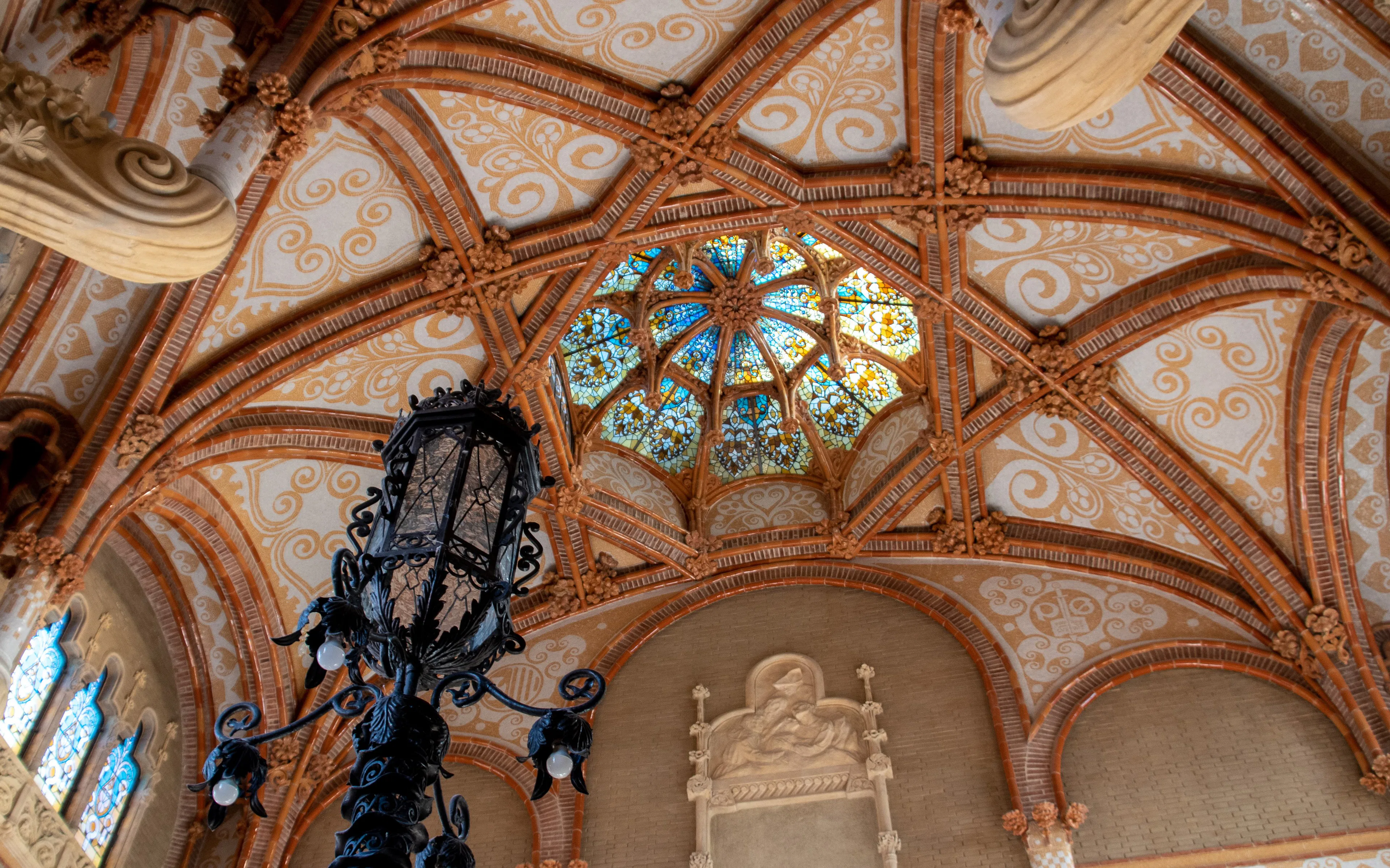 Interior of Recinte Modernista de Sant Pau with Gothic dome and stained glass.